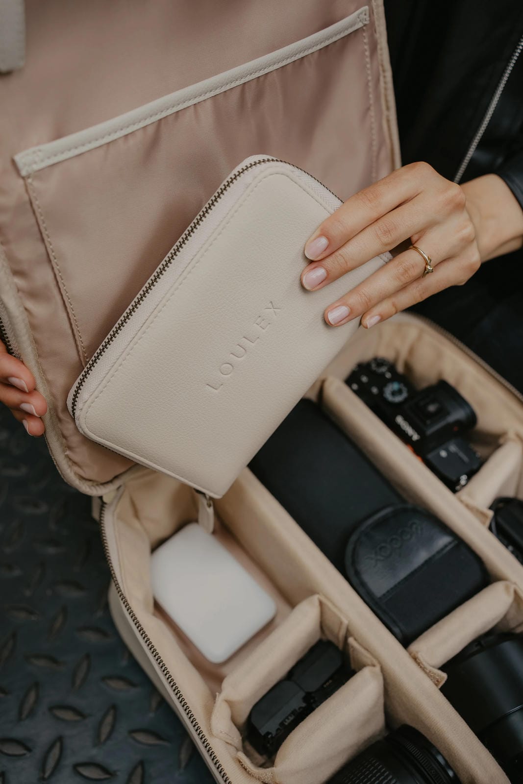 Camera bag with compartments containing camera equipment, featuring the Lovley brand.
