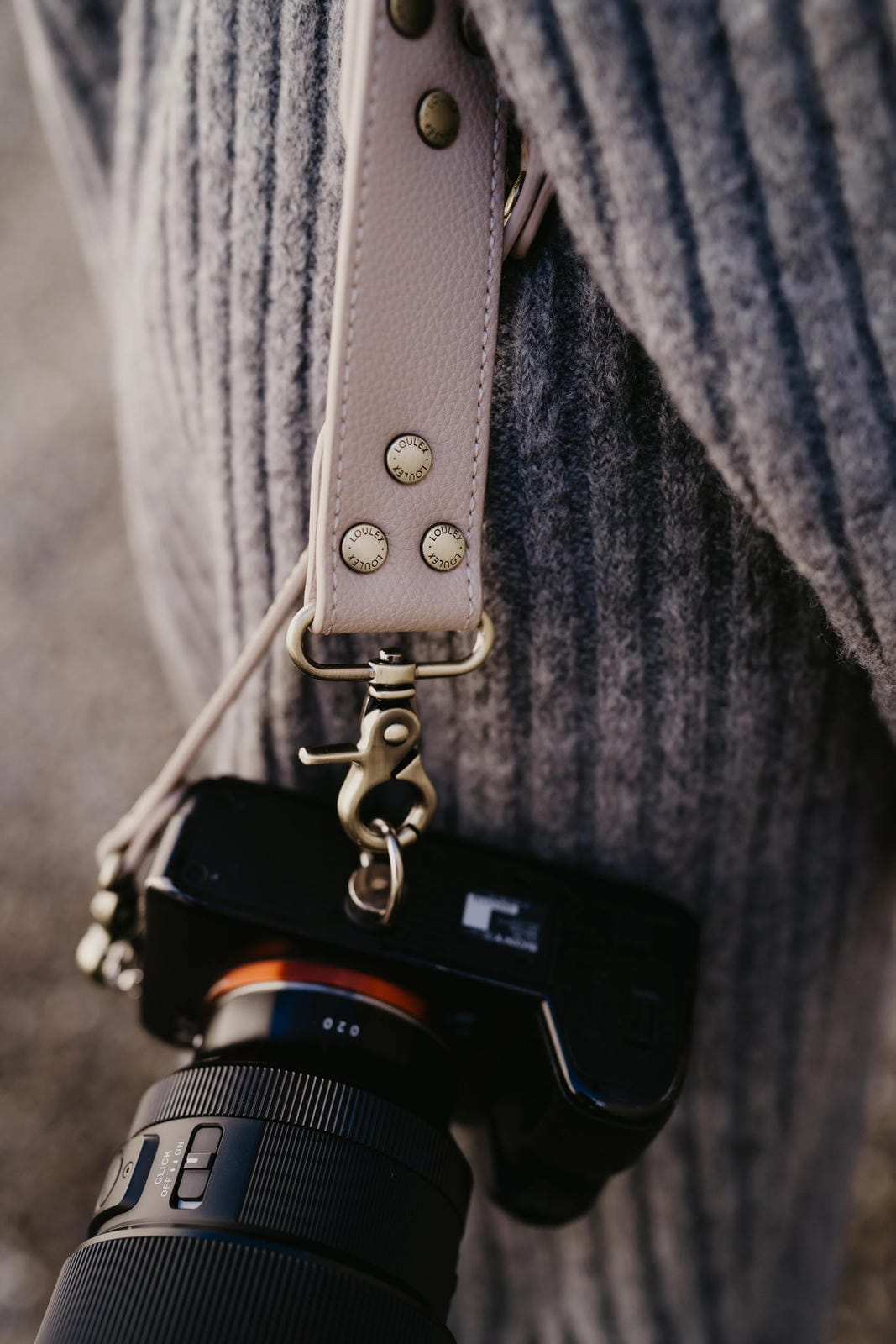 Camera with a strap over a textured surface