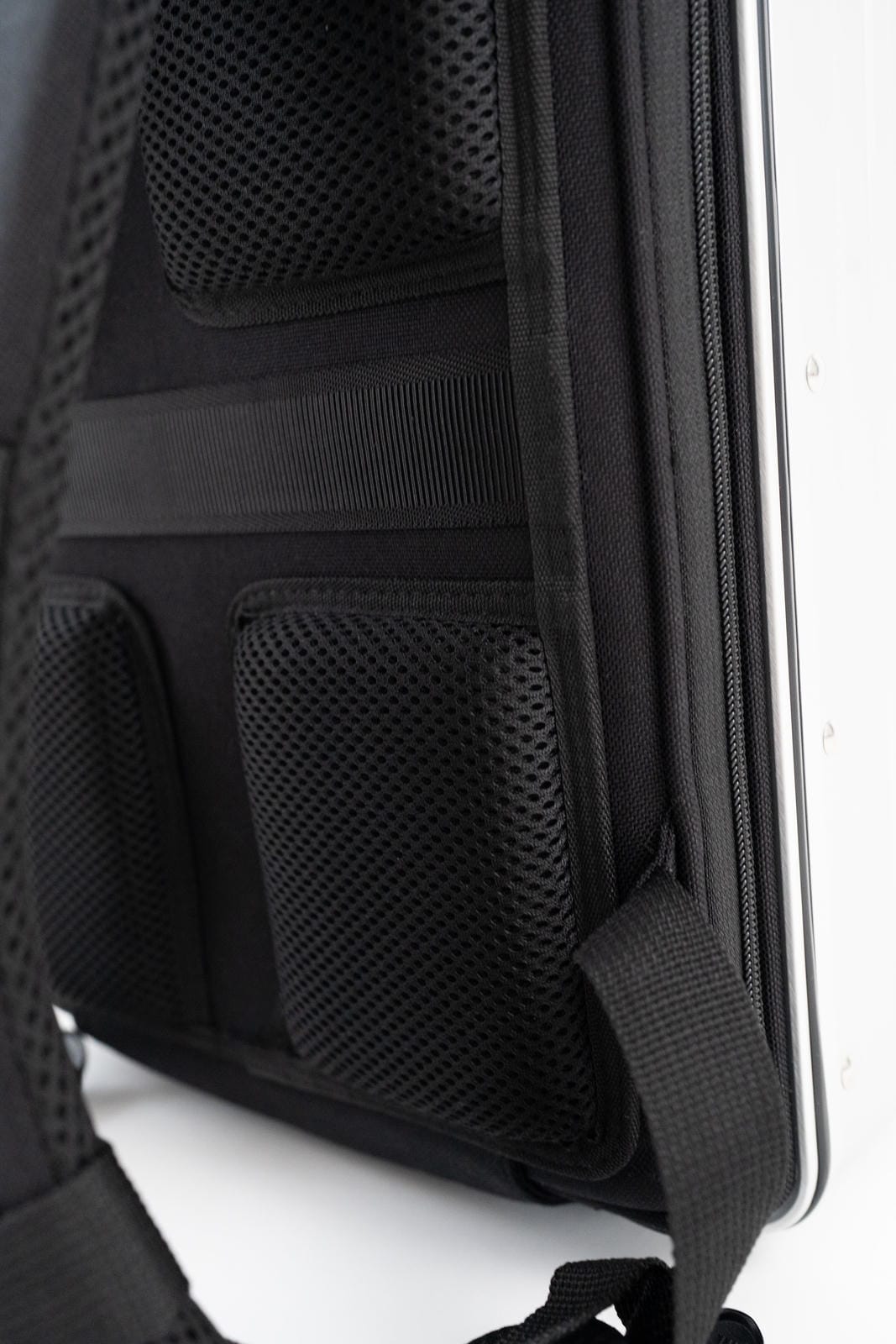 Close-up of a black backpack with a white background
