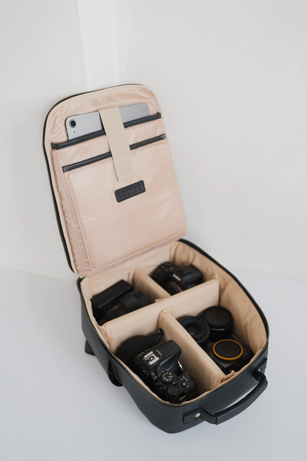 Camera case with compartments for camera equipment on a white background