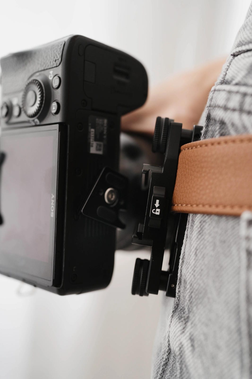 Camera mounted on a belt with a neutral background