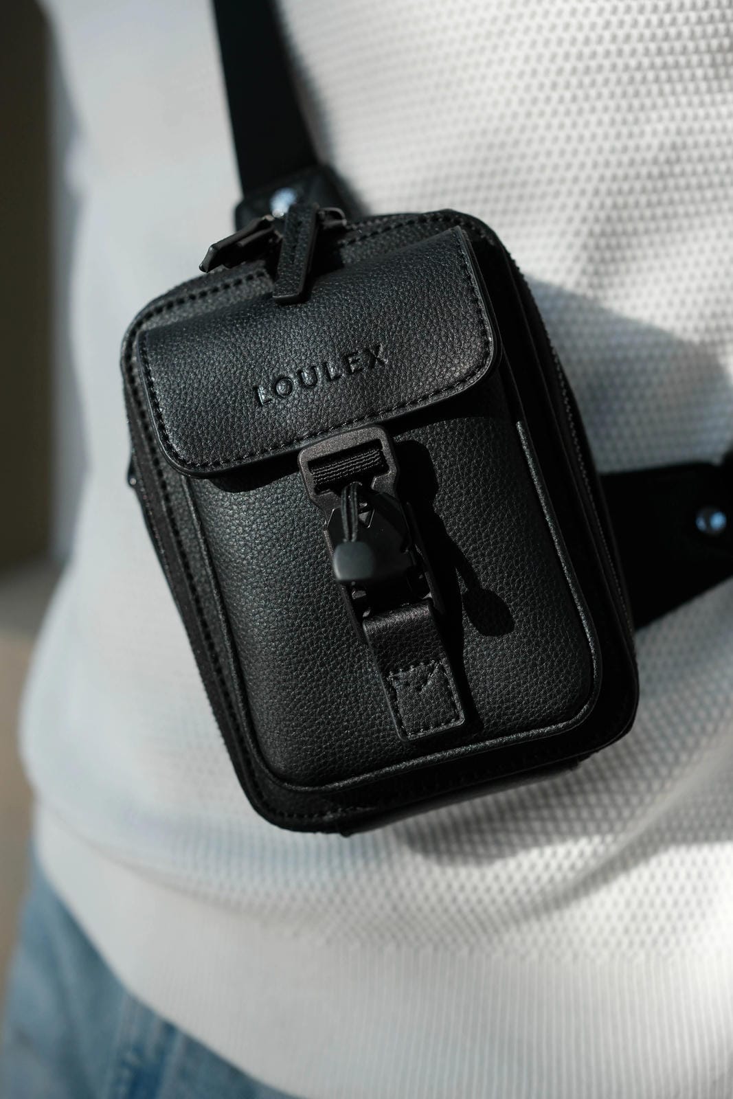 Black pouch with 'LOULEX' branding worn over one shoulder.