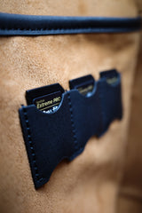 Primo piano di una borsa in pelle marrone con un portacarte blu con il marchio "Extreme Pro".
