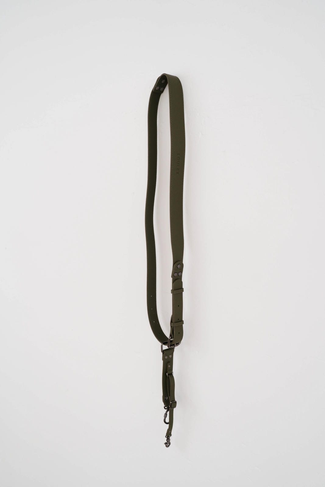 Green strap with a metal clip on a white background