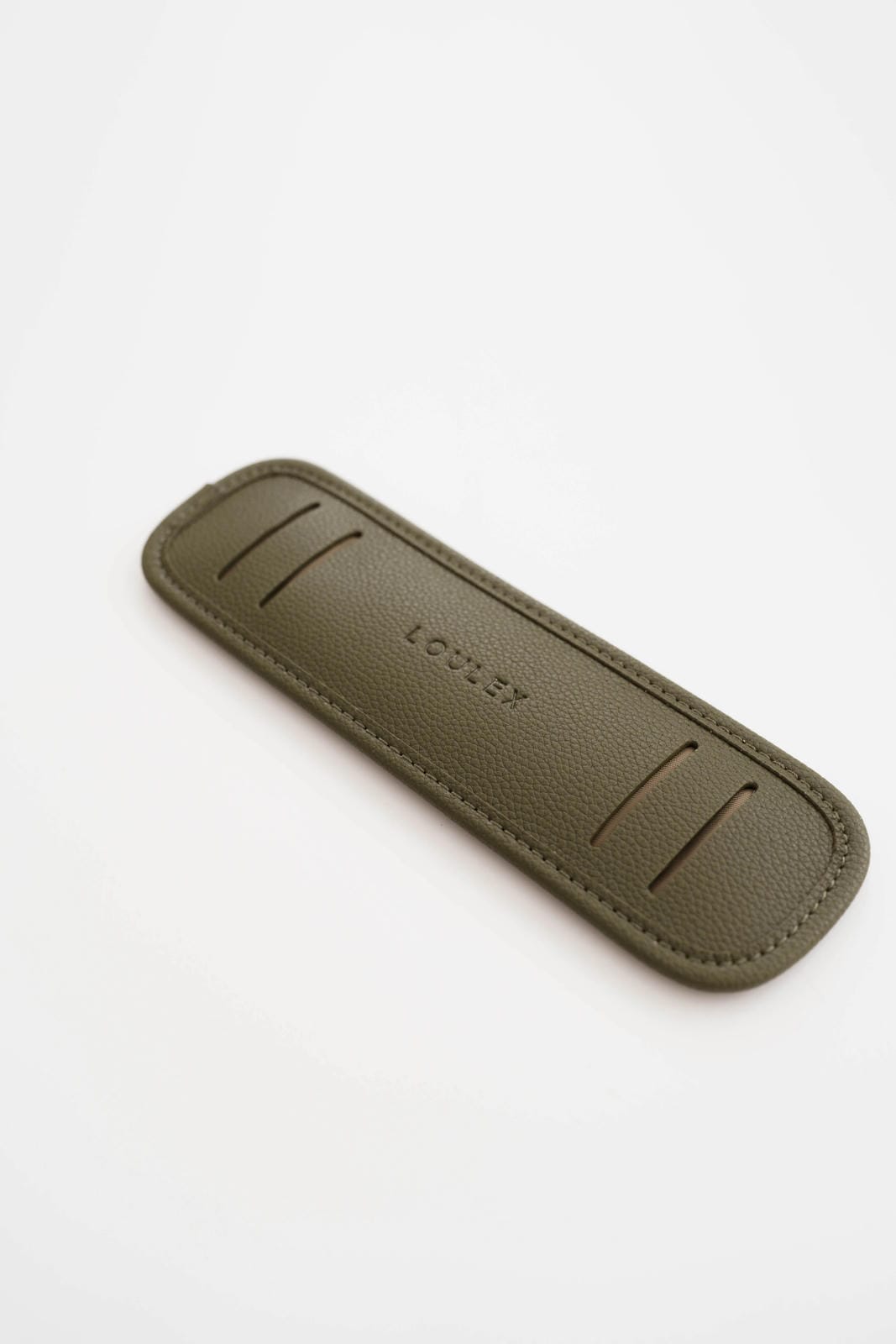 Green leather knife sheath on a white background