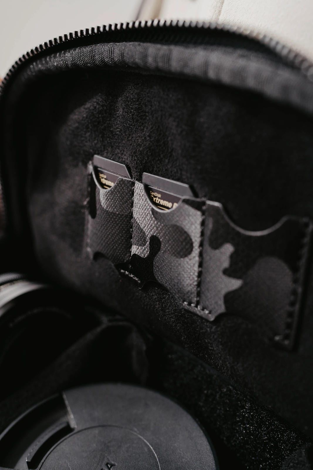 Black and gray camouflage patch on a textured surface