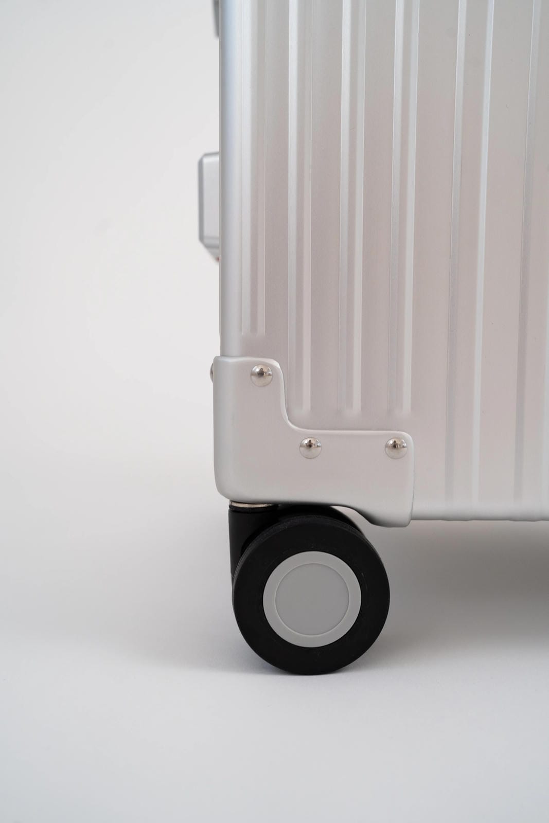 Close-up of a silver suitcase with a white background