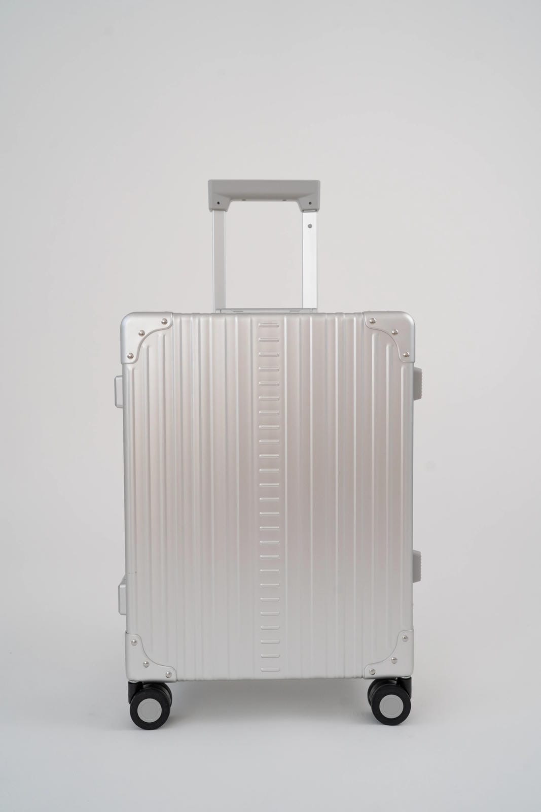 Silver suitcase with a textured surface on a white background