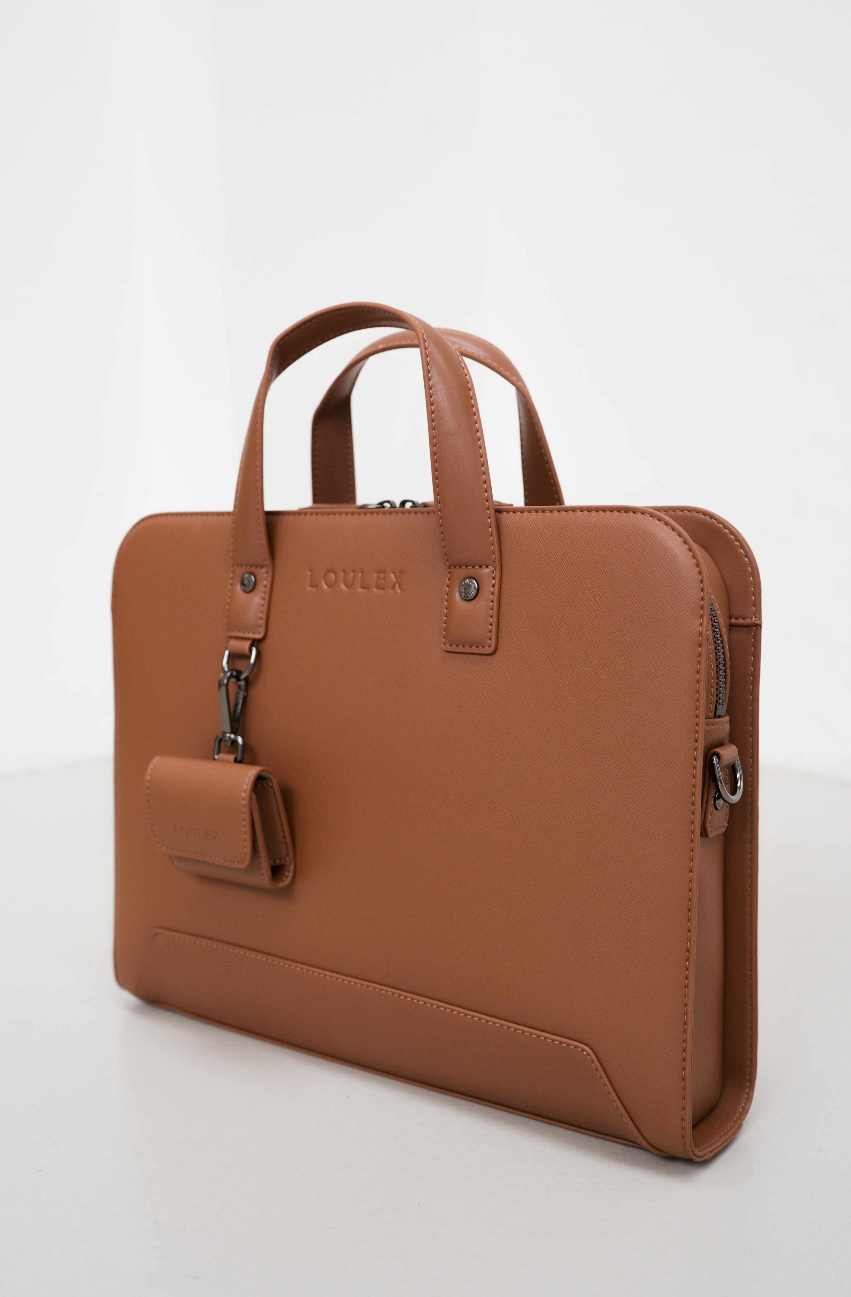 Brown leather briefcase with a detachable handle on a white background