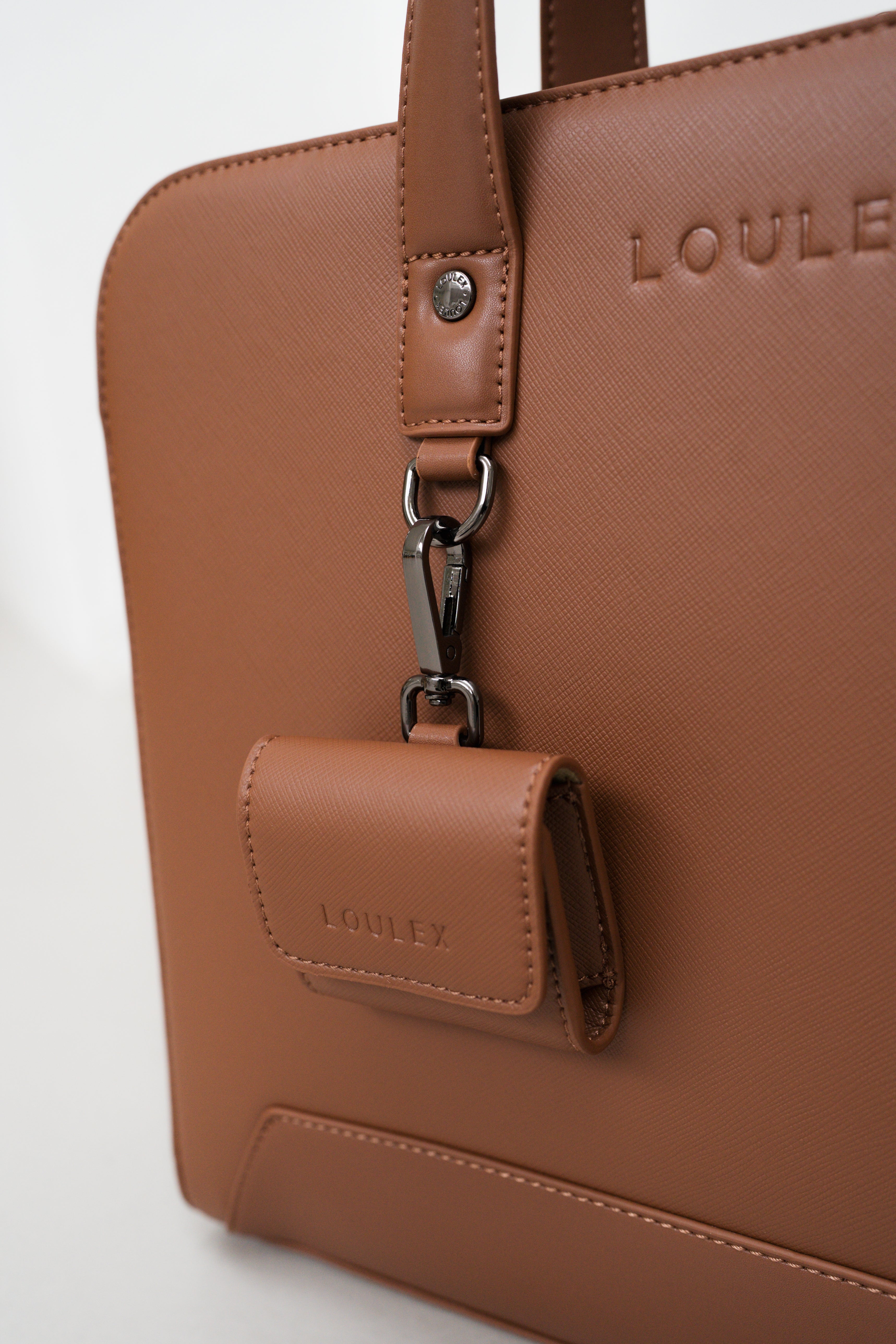 Brown handbag with a attached wallet and 'LOULE' branding on a light gray background