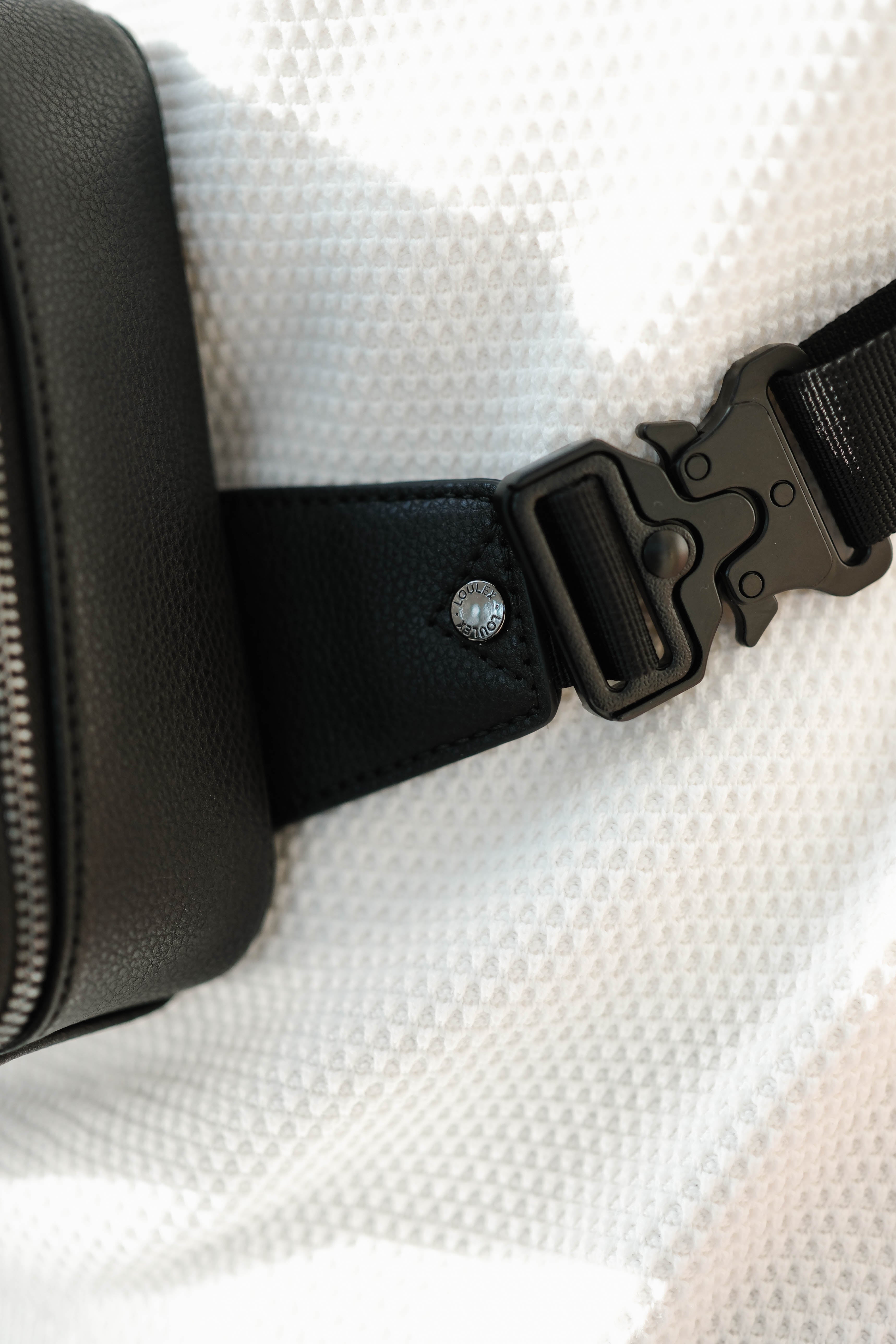 leather bag with 'LOULEX' 