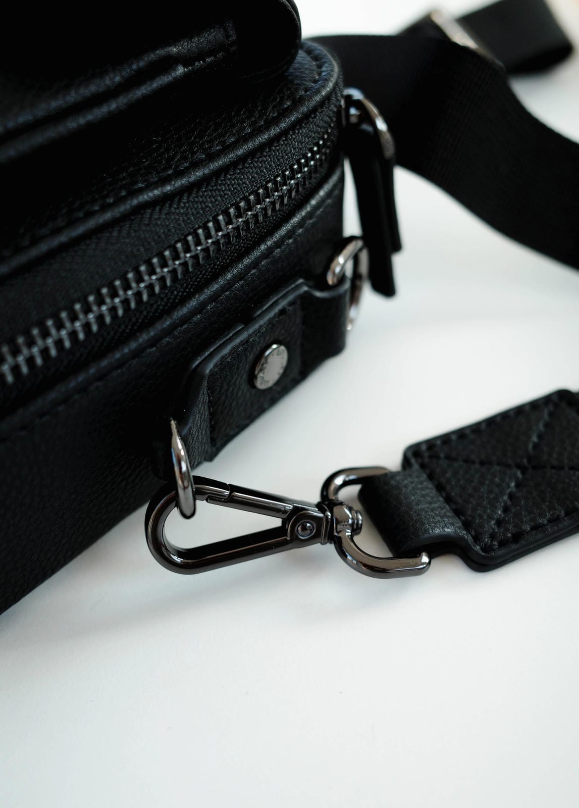 Black bag with a strap on a white background